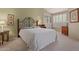 Well-lit bedroom featuring a comfortable bed, neutral green walls, and window with shutter at 9104 E Hillery Dr, Scottsdale, AZ 85260