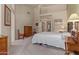 Spacious bedroom with vaulted ceiling features traditional decor, and light-colored walls at 9104 E Hillery Dr, Scottsdale, AZ 85260