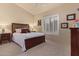 Cozy bedroom showcasing a comfortable bed, shuttered window, and neutral paint color at 9104 E Hillery Dr, Scottsdale, AZ 85260