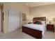 Tranquil bedroom features a comfortable bed, neutral paint, and a closet with sliding doors at 9104 E Hillery Dr, Scottsdale, AZ 85260