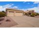 Charming single-story home with a tile roof, desert landscaping, and a spacious three-car garage at 9104 E Hillery Dr, Scottsdale, AZ 85260