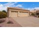 Charming single-story home with a tile roof, desert landscaping, and a spacious three-car garage at 9104 E Hillery Dr, Scottsdale, AZ 85260