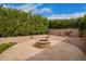 Stone fire pit area with gravel, ideal for outdoor gatherings at 9104 E Hillery Dr, Scottsdale, AZ 85260