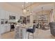 Bright kitchen with a granite island and stainless steel appliances seamlessly connected to the dining area at 9104 E Hillery Dr, Scottsdale, AZ 85260