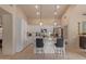 Modern kitchen with white cabinets, granite countertops, and stainless steel appliances, creating a sleek and functional space at 9104 E Hillery Dr, Scottsdale, AZ 85260