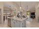 Bright kitchen with a granite island and stainless steel appliances overlooks the living and dining areas at 9104 E Hillery Dr, Scottsdale, AZ 85260