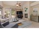 Cozy living room featuring a fireplace, entertainment center, and plush seating arrangement at 9104 E Hillery Dr, Scottsdale, AZ 85260