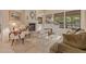 Bright living room featuring a white piano, fireplace, and large windows offering great natural light at 9104 E Hillery Dr, Scottsdale, AZ 85260