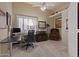 Home office featuring a ceiling fan, plush carpet, and desk with chair set in front of a window at 9104 E Hillery Dr, Scottsdale, AZ 85260