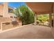 Covered patio featuring a built-in outdoor kitchen, stone tile flooring, and ample space for entertaining at 9104 E Hillery Dr, Scottsdale, AZ 85260