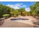 Backyard featuring a small pool and beautifully landscaped with lush greenery at 9104 E Hillery Dr, Scottsdale, AZ 85260