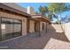 Enclosed backyard featuring gravel and a covered patio connected to the home by multiple glass doors at 924 W Boxelder Pl, Chandler, AZ 85225