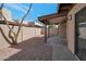 Enclosed backyard covered with gravel and showcasing a covered patio area with a sliding glass door at 924 W Boxelder Pl, Chandler, AZ 85225