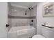 Stylish bathroom showcasing tub with sleek, dark shower fixtures, decorative tile, and modern neutral-toned design at 924 W Boxelder Pl, Chandler, AZ 85225