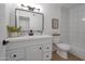 Bright, renovated bathroom features modern vanity with decorative mirror and fixtures, with tile backsplash and shower at 924 W Boxelder Pl, Chandler, AZ 85225