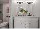 Double sink vanity with framed mirrors and elegant lighting in a renovated bathroom at 924 W Boxelder Pl, Chandler, AZ 85225