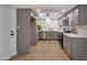 Modern kitchen with sleek gray cabinets, stainless steel appliances, stylish backsplash, and quartz countertops at 924 W Boxelder Pl, Chandler, AZ 85225