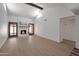 Inviting living room features a cozy fireplace, wooden beam, and light-colored wood floors, with double glass doors to the exterior at 924 W Boxelder Pl, Chandler, AZ 85225