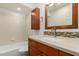 Bathroom with a tiled shower-over-tub and a granite vanity at 945 N Pasadena St # 61, Mesa, AZ 85201