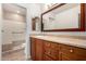 Well-lit bathroom featuring a tiled walk-in shower with grab bars and a spacious vanity at 945 N Pasadena St # 61, Mesa, AZ 85201