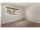 Well-lit bedroom with neutral carpet and a large window offering backyard views at 945 N Pasadena St # 61, Mesa, AZ 85201