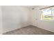 Bright bedroom with neutral carpet, featuring a window that offers natural light at 945 N Pasadena St # 61, Mesa, AZ 85201