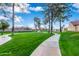 Community walking path and green space with mature shade trees at 945 N Pasadena St # 61, Mesa, AZ 85201