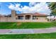 Charming home featuring stucco siding, a red tile roof, and lush green grass and landscaping at 945 N Pasadena St # 61, Mesa, AZ 85201