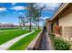 Exterior view showcases community green space, walking path, and colorful flower boxes at 945 N Pasadena St # 61, Mesa, AZ 85201