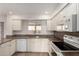 Well-lit kitchen features white cabinets and granite countertops at 945 N Pasadena St # 61, Mesa, AZ 85201