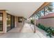 A covered patio featuring a concrete floor with brick accents and access to the home through sliding glass doors at 945 N Pasadena St # 61, Mesa, AZ 85201