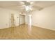 Bedroom featuring hardwood floors, neutral walls, ceiling fan and entrances to bath and closet at 10330 W Thunderbird Blvd # B101, Sun City, AZ 85351