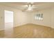 Bright bedroom with hard flooring, white walls, ceiling fan, and window with plantation shutters at 10330 W Thunderbird Blvd # B101, Sun City, AZ 85351