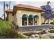 Clubhouse with covered front porch, desert landscaping, flowering shrubs and decorative pond at 10330 W Thunderbird Blvd # B101, Sun City, AZ 85351