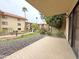 Paver patio with view of community landscaping, including lawns, flowering plants, gravel beds and palm trees at 10330 W Thunderbird Blvd # B101, Sun City, AZ 85351