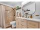 Stylish bathroom features a modern vanity, decorative mirror, and updated shower with neutral earth-toned tiling and elegant fixtures at 10406 E Silvertree Dr, Sun Lakes, AZ 85248