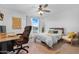 Bright bedroom features a ceiling fan and a workstation with a view to the backyard pool at 10406 E Silvertree Dr, Sun Lakes, AZ 85248