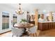 Dining room featuring round table, stylish chandelier, and backyard access at 10406 E Silvertree Dr, Sun Lakes, AZ 85248