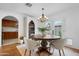 Dining room featuring round table, stylish chandelier, and view of the yard at 10406 E Silvertree Dr, Sun Lakes, AZ 85248