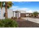 Single-story home with desert landscaping and brick paved drive leading to gated entry at 10406 E Silvertree Dr, Sun Lakes, AZ 85248