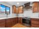 Updated kitchen with marble counters, stainless steel appliances, and wooden cabinets at 10406 E Silvertree Dr, Sun Lakes, AZ 85248