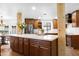 Kitchen island features white countertop and sink with wooden cabinetry at 10406 E Silvertree Dr, Sun Lakes, AZ 85248