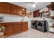 Spacious laundry room featuring updated washer and dryer, decorative flooring and ample storage cabinetry and counterspace at 10406 E Silvertree Dr, Sun Lakes, AZ 85248