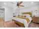 Beautifully decorated main bedroom with a ceiling fan and view of the bathroom vanity at 10406 E Silvertree Dr, Sun Lakes, AZ 85248