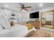 Bright main bedroom with a ceiling fan, patio doors and a view of the backyard at 10406 E Silvertree Dr, Sun Lakes, AZ 85248