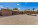 Expansive backyard with desert landscaping, a covered patio, gazebo with outdoor seating, and ample space for entertaining at 10718 W Saratoga Cir, Sun City, AZ 85351