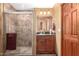 Bathroom featuring a glass shower and a wooden vanity at 10718 W Saratoga Cir, Sun City, AZ 85351