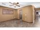 Bedroom with tile flooring, shuttered window, and attached bathroom at 10718 W Saratoga Cir, Sun City, AZ 85351