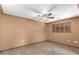 Empty bedroom with tile flooring, ceiling fan, and window with shutter providing lots of light at 10718 W Saratoga Cir, Sun City, AZ 85351