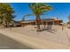 Inviting home with a wide driveway, stone accents, solar panels, and desert landscaping under a clear blue sky at 10718 W Saratoga Cir, Sun City, AZ 85351